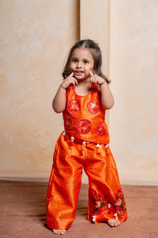 Brighten celebrations with this playful orange floral crop top and palazzo set for girls - Kirti Agarwal