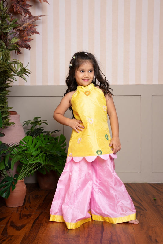 Charming yellow halter - neck kurti with scalloped hem and pink palazzo set, perfect for festive celebrations. - Kirti Agarwal