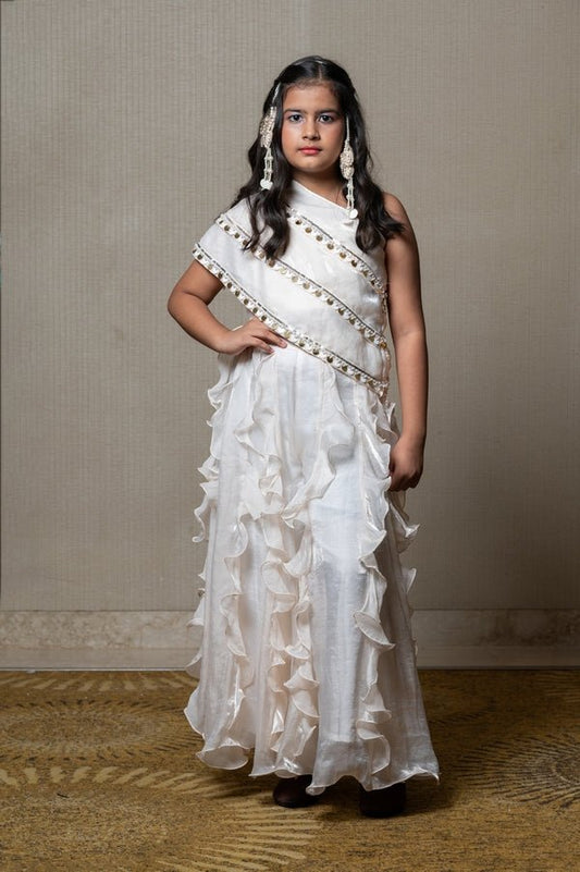 Elegant ivory one - shoulder gown with cascading ruffles and sequin embellishments, perfect for making a chic statement at any special occasion - Kirti Agarwal