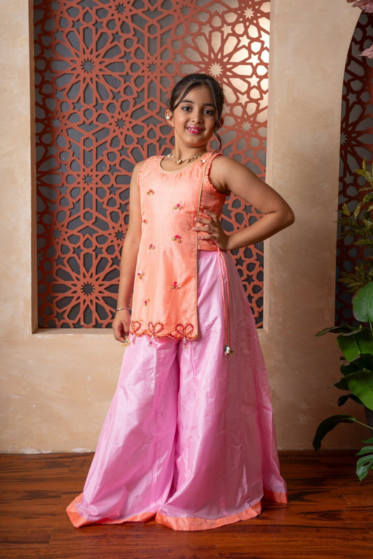 Orange embroidered kurti with flared pink palazzos — a vibrant and elegant ensemble for festive flair. - Kirti Agarwal