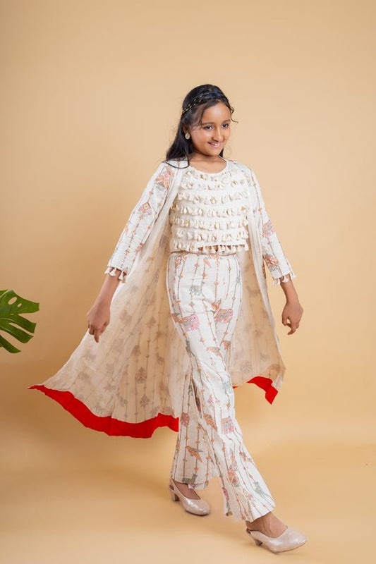 Vibrant ivory ensemble with colorful prints and tassel accents, perfect for a chic and playful look at any festive occasion. - Kirti Agarwal