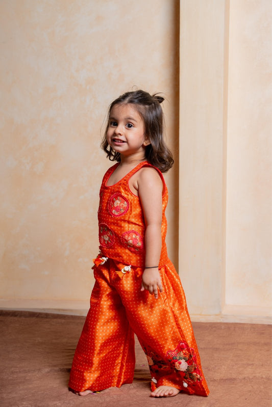 Brighten celebrations with this playful orange floral crop top and palazzo set for girls - Kirti Agarwal