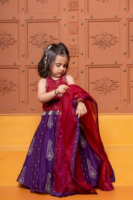Bring festive elegance to her look with this maroon crop top and purple lehenga set for girls. - Kirti Agarwal