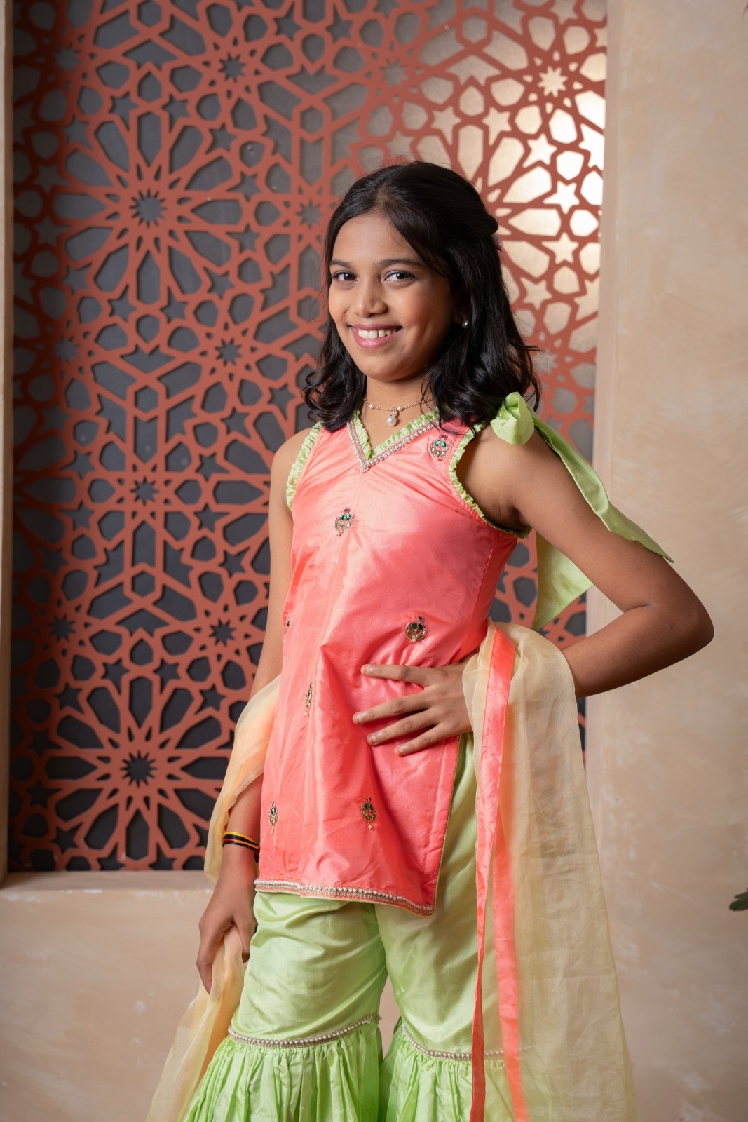Charming orange and green sharara set with delicate embroidery and contrast dupatta — a joyful festive outfit for your little one. - Kirti Agarwal