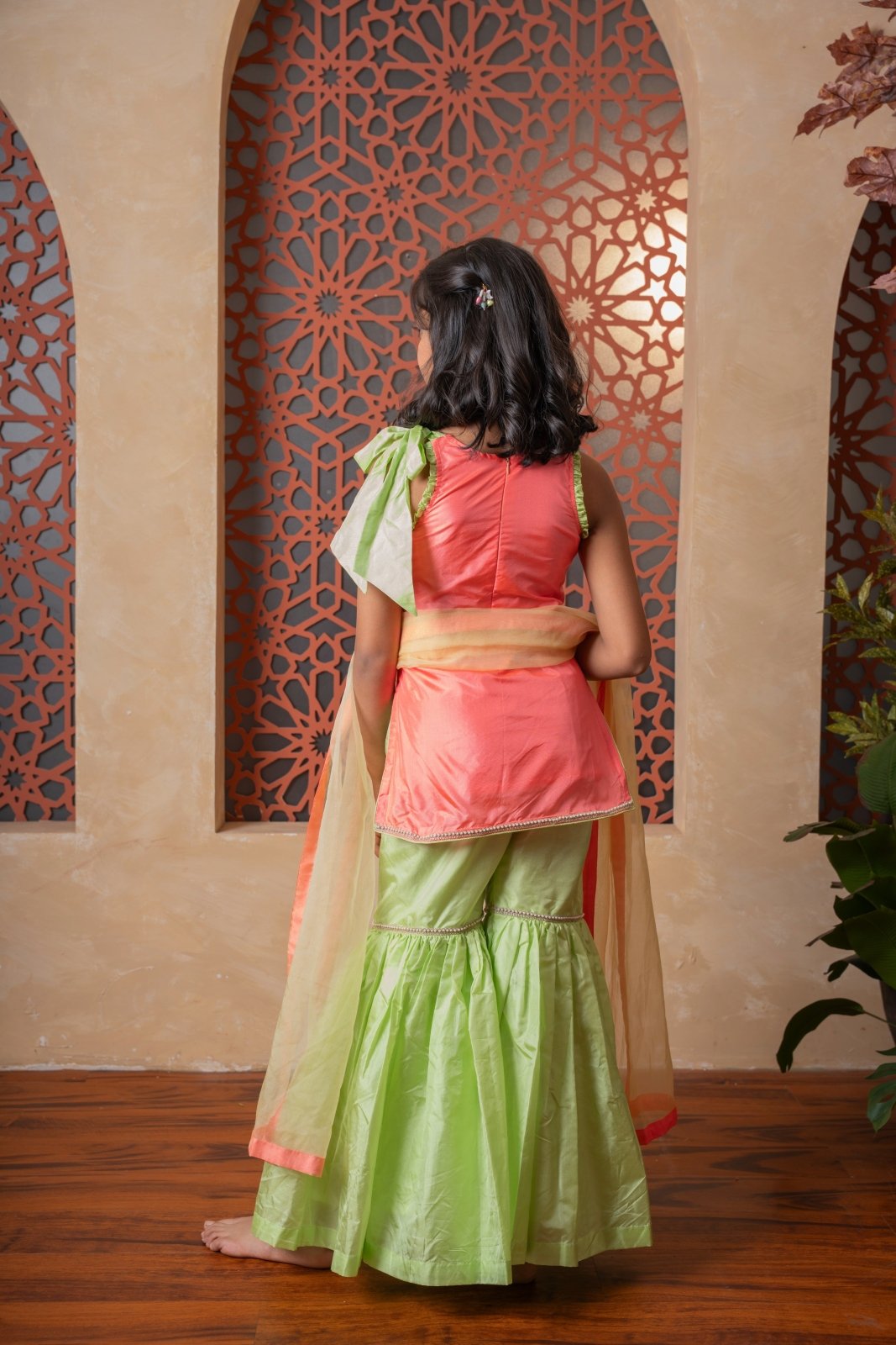 Charming orange and green sharara set with delicate embroidery and contrast dupatta — a joyful festive outfit for your little one. - Kirti Agarwal