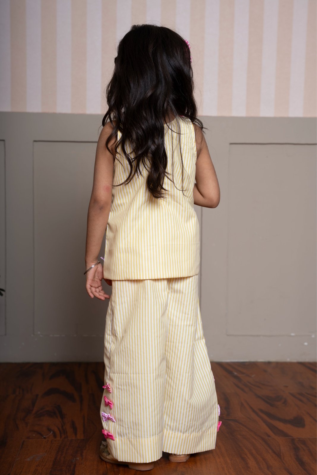Charming yellow striped coord set with bow accents — a cheerful and comfy pick for your little fashionista. - Kirti Agarwal
