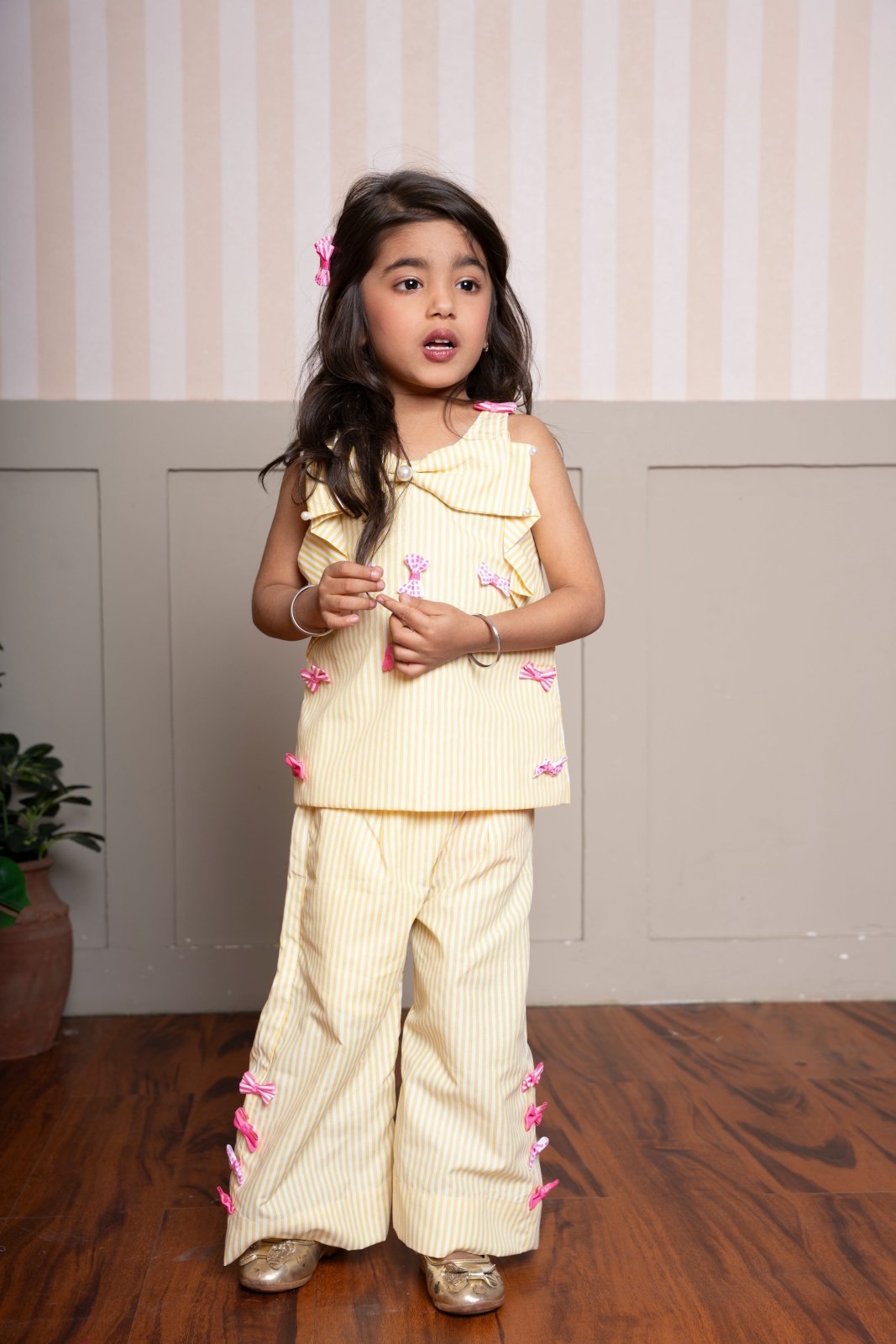 Charming yellow striped coord set with bow accents — a cheerful and comfy pick for your little fashionista. - Kirti Agarwal