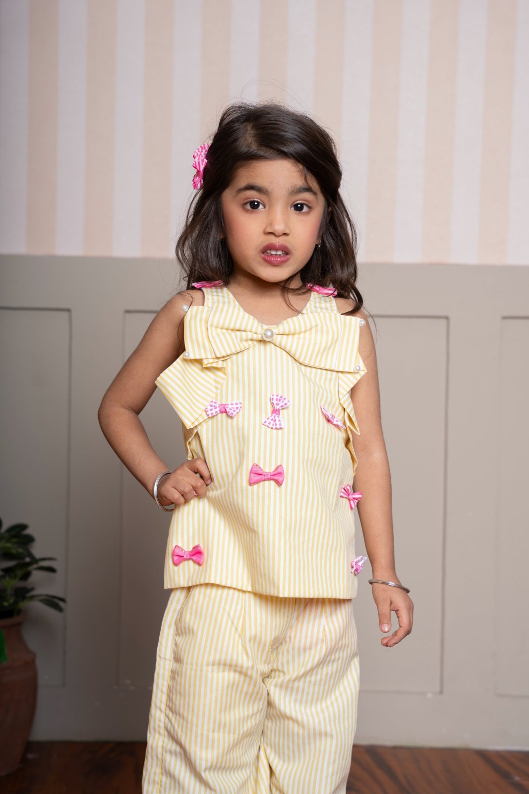 Charming yellow striped coord set with bow accents — a cheerful and comfy pick for your little fashionista. - Kirti Agarwal