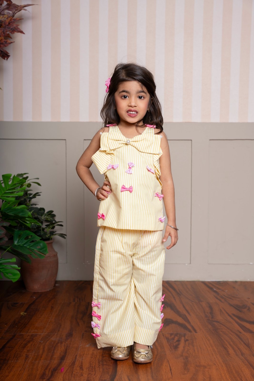 Charming yellow striped coord set with bow accents — a cheerful and comfy pick for your little fashionista. - Kirti Agarwal