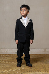 Classic black blazer with a champagne metallic - textured lapel, paired with matching pants and a crisp white shirt for a sophisticated formal look - Kirti Agarwal