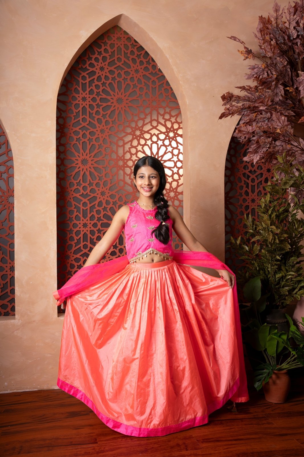 Elegant pink and orange lehenga set with intricate hand embroidery and tassel - detailed dupatta — perfect for festive occasions. - Kirti Agarwal