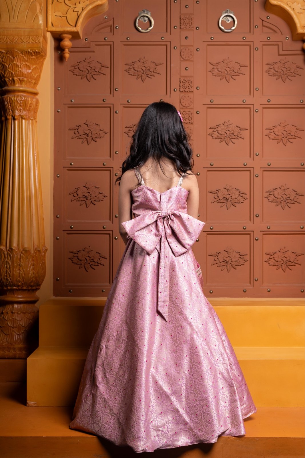 Elegant pink brocade lehenga set for girls with stylish ruched crop top, embroidered pockets, and statement back bow – perfect kids ethnic wear for weddings and parties - Kirti Agarwal