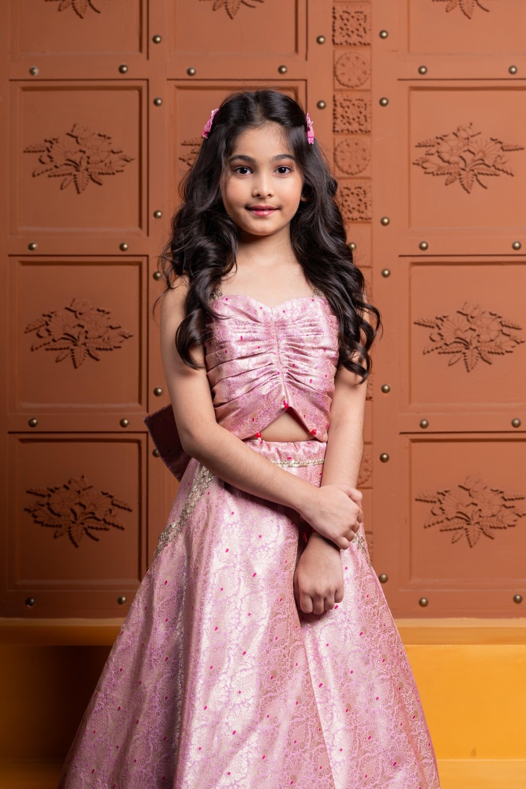 Elegant pink brocade lehenga set for girls with stylish ruched crop top, embroidered pockets, and statement back bow – perfect kids ethnic wear for weddings and parties - Kirti Agarwal