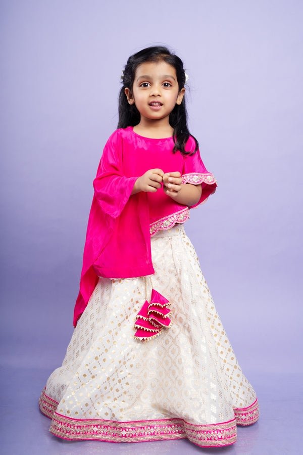 Elegant pink cape top with a white and gold lehenga, perfect for festive celebrations - Kirti Agarwal