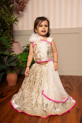 Graceful cream lehenga set with golden palace print and vibrant pink highlights for a festive royal charm. - Kirti Agarwal