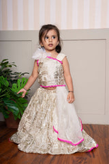 Graceful cream lehenga set with golden palace print and vibrant pink highlights for a festive royal charm. - Kirti Agarwal