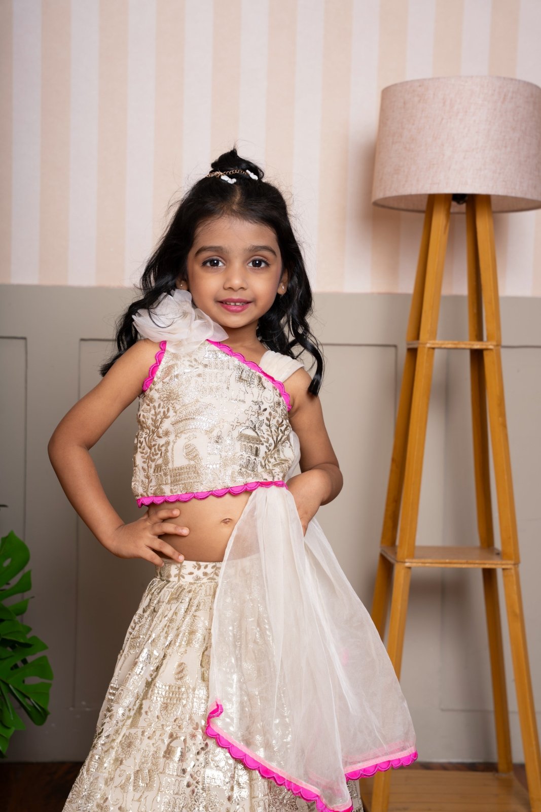 Graceful cream lehenga set with golden palace print and vibrant pink highlights for a festive royal charm. - Kirti Agarwal