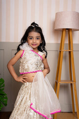 Graceful cream lehenga set with golden palace print and vibrant pink highlights for a festive royal charm. - Kirti Agarwal