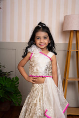 Graceful cream lehenga set with golden palace print and vibrant pink highlights for a festive royal charm. - Kirti Agarwal