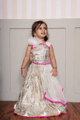 Graceful cream lehenga set with golden palace print and vibrant pink highlights for a festive royal charm. - Kirti Agarwal