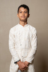 Intricately embroidered off - white bandhgala with matching white kurta and pants for an elegant traditional look - Kirti Agarwal