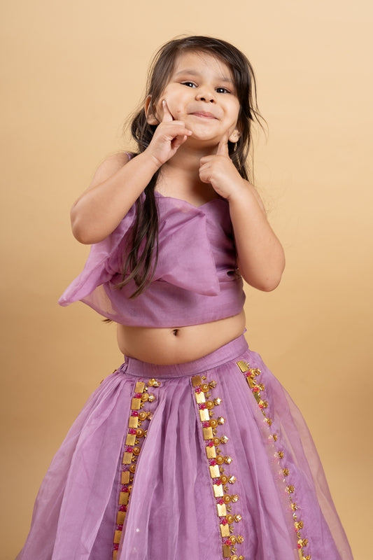 Lavender lehenga with an asymmetrical top, adorned with gold and pink embellishments