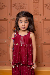 Maroon kids festive set with embroidered peplum top and flared skirt, highlighted with cowrie shell detailing. - Kirti Agarwal