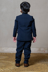 Navy blue blazer with elegant metallic embroidery, paired with matching trousers and a crisp white shirt for a refined formal look - Kirti Agarwal