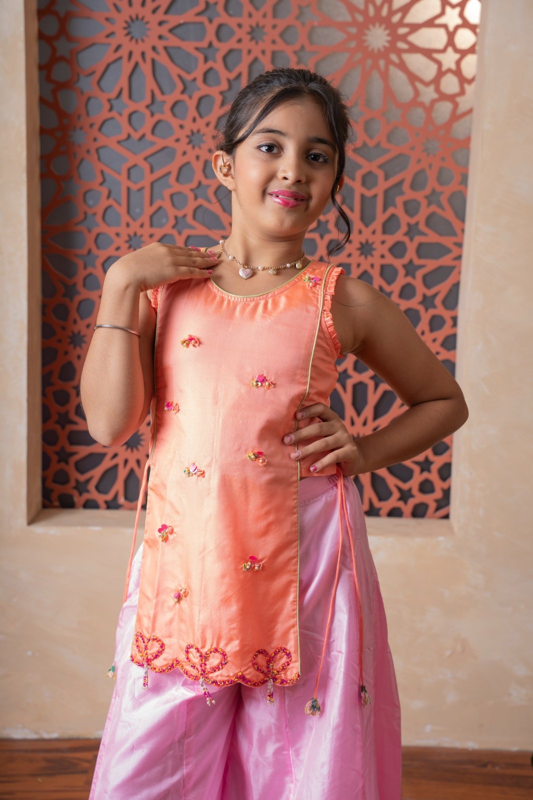Orange embroidered kurti with flared pink palazzos — a vibrant and elegant ensemble for festive flair. - Kirti Agarwal