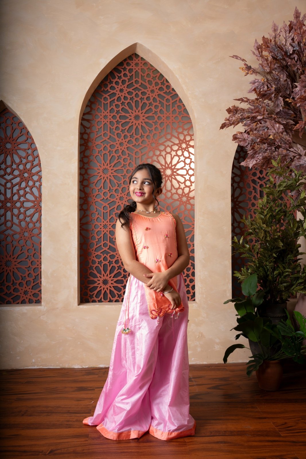 Orange embroidered kurti with flared pink palazzos — a vibrant and elegant ensemble for festive flair. - Kirti Agarwal
