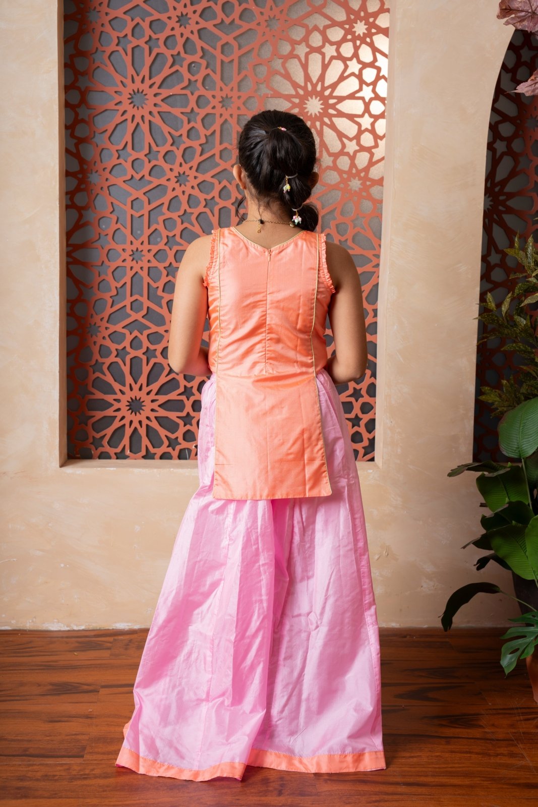 Orange embroidered kurti with flared pink palazzos — a vibrant and elegant ensemble for festive flair. - Kirti Agarwal