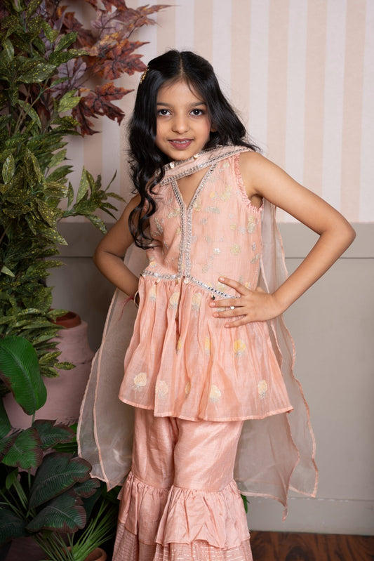 Peach peplum sharara set with dupatta and shimmer - layered ruffles for a festive - ready look. - Kirti Agarwal
