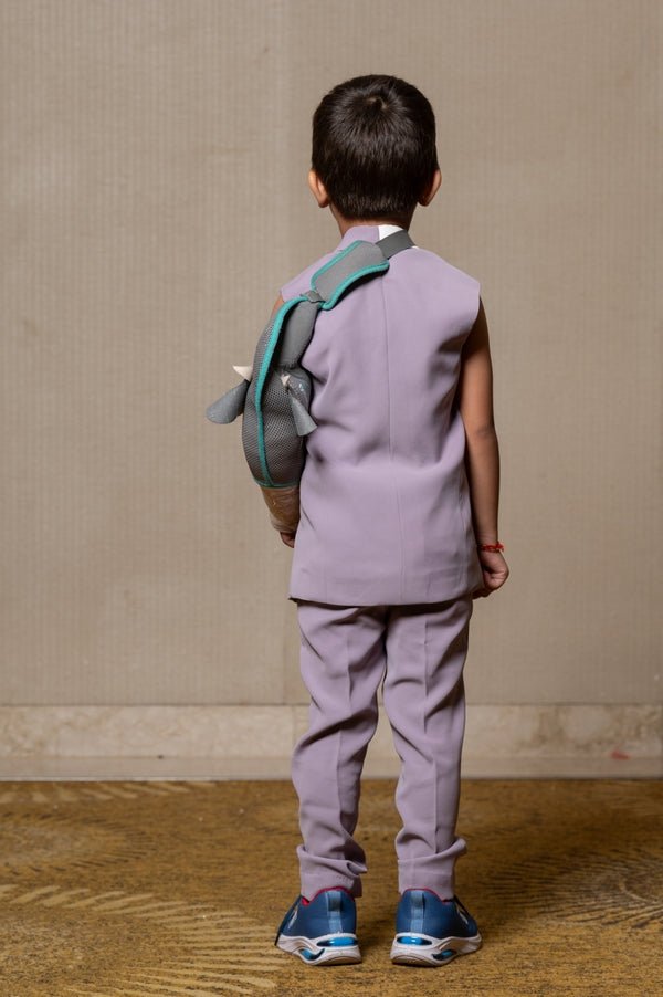 Stylish sleeveless lavender blazer with a modern asymmetrical white lapel, paired with matching slim - fit trousers for a contemporary formal look. - Kirti Agarwal