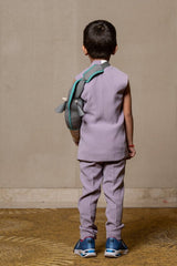 Stylish sleeveless lavender blazer with a modern asymmetrical white lapel, paired with matching slim - fit trousers for a contemporary formal look. - Kirti Agarwal