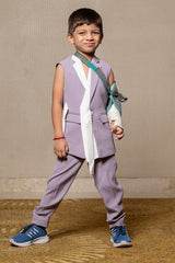 Stylish sleeveless lavender blazer with a modern asymmetrical white lapel, paired with matching slim - fit trousers for a contemporary formal look. - Kirti Agarwal