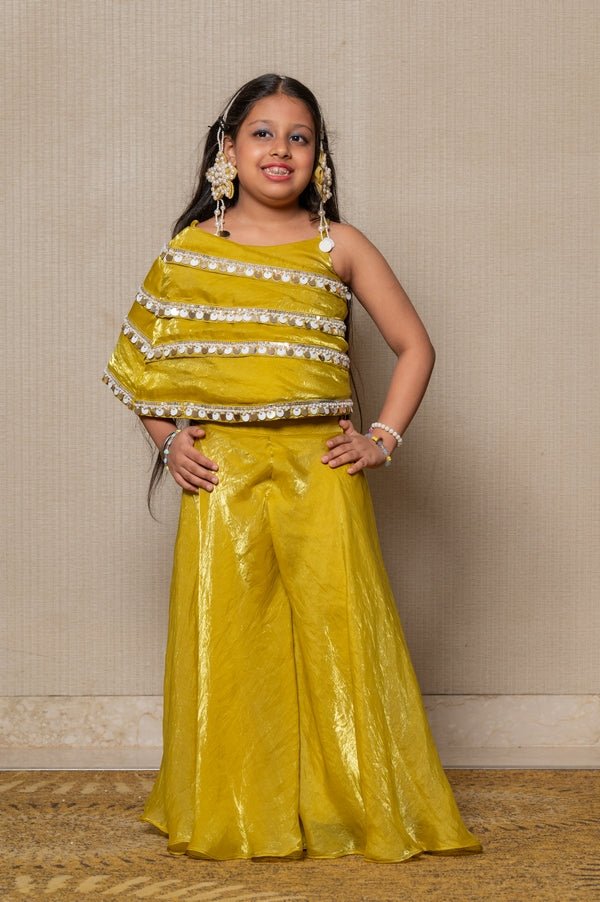 Vibrant golden - yellow ensemble with an asymmetrical top and wide - legged pants, perfect for making a bold statement at any festive occasion. - Kirti Agarwal