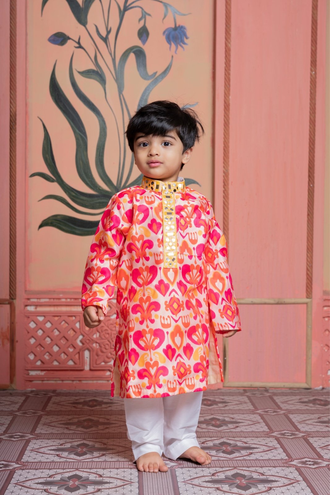 Vibrant printed kurta paired with classic white pyjama, finished with elegant mirror detailing. - Kirti Agarwal