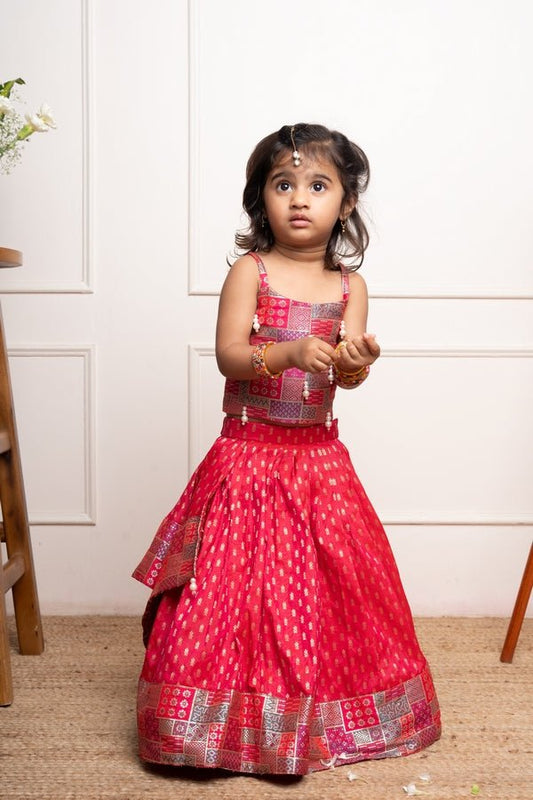 Vibrant red lehenga set with a multicolored patchwork blouse and golden motif print, perfect for festive occasions - Kirti Agarwal