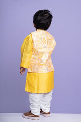 Vibrant yellow kurta set with an embroidered Peach Nehru jacket, paired with classic white churidar pants for a festive look - Kirti Agarwal